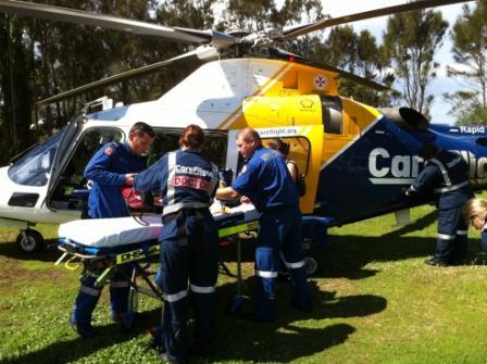 CareFlight doctors prepare to fly an injured three-year-old boy to hospital from Umina Beach after he fell head-first onto concrete at the weekend. 